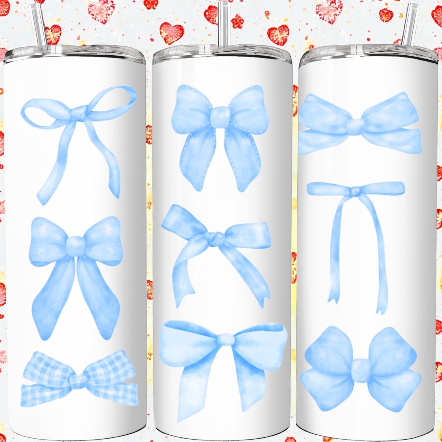 Three white tumblers with blue bow designs on a colorful heart-patterned background