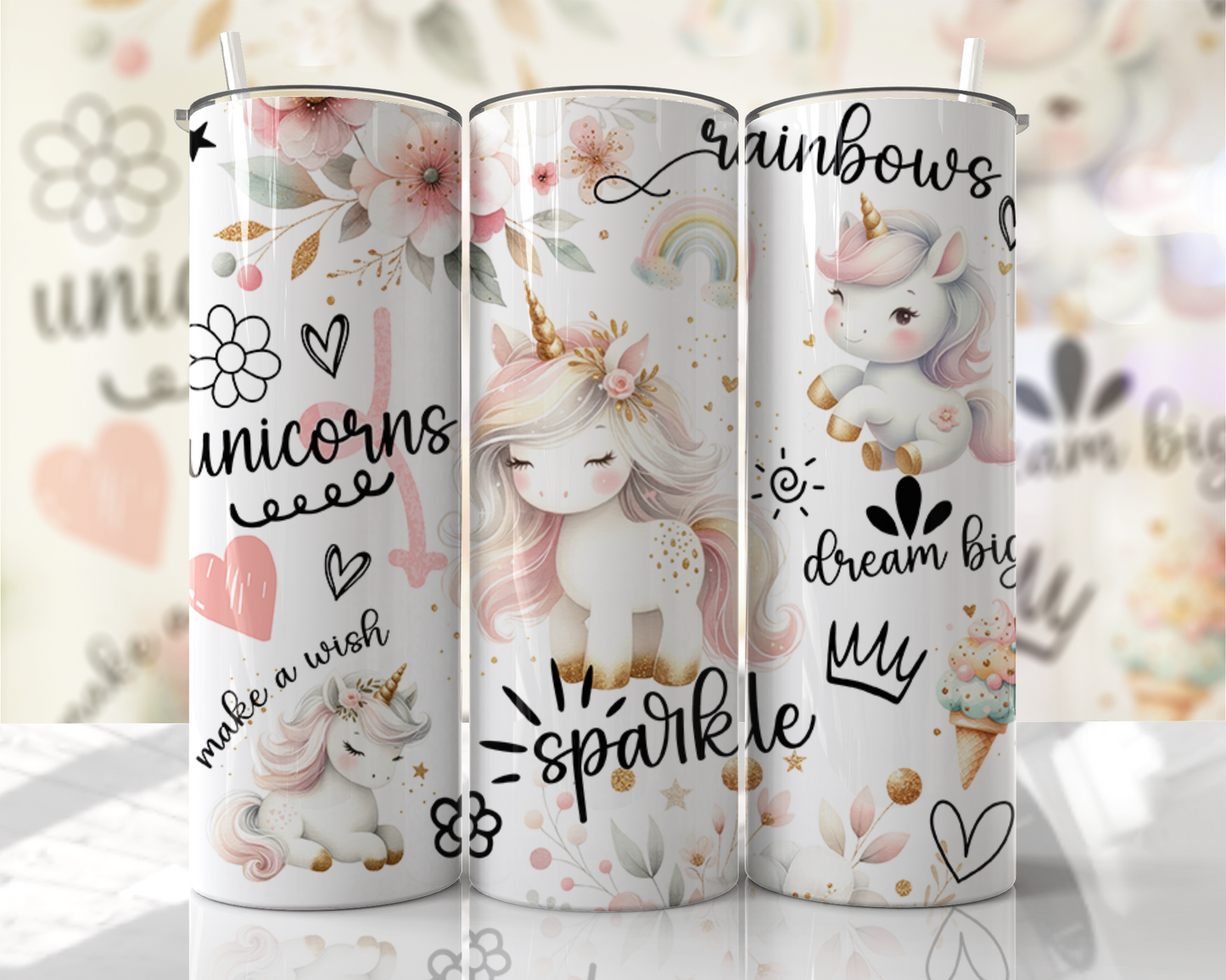Three unicorn-themed tumblers with decorative designs on a blurred background.