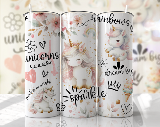 Three unicorn-themed tumblers with decorative designs on a blurred background.