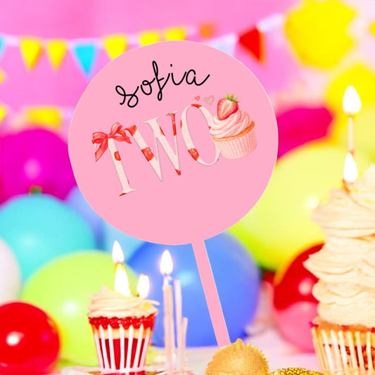 Birthday cake with candles and a pink sign on a colorful background