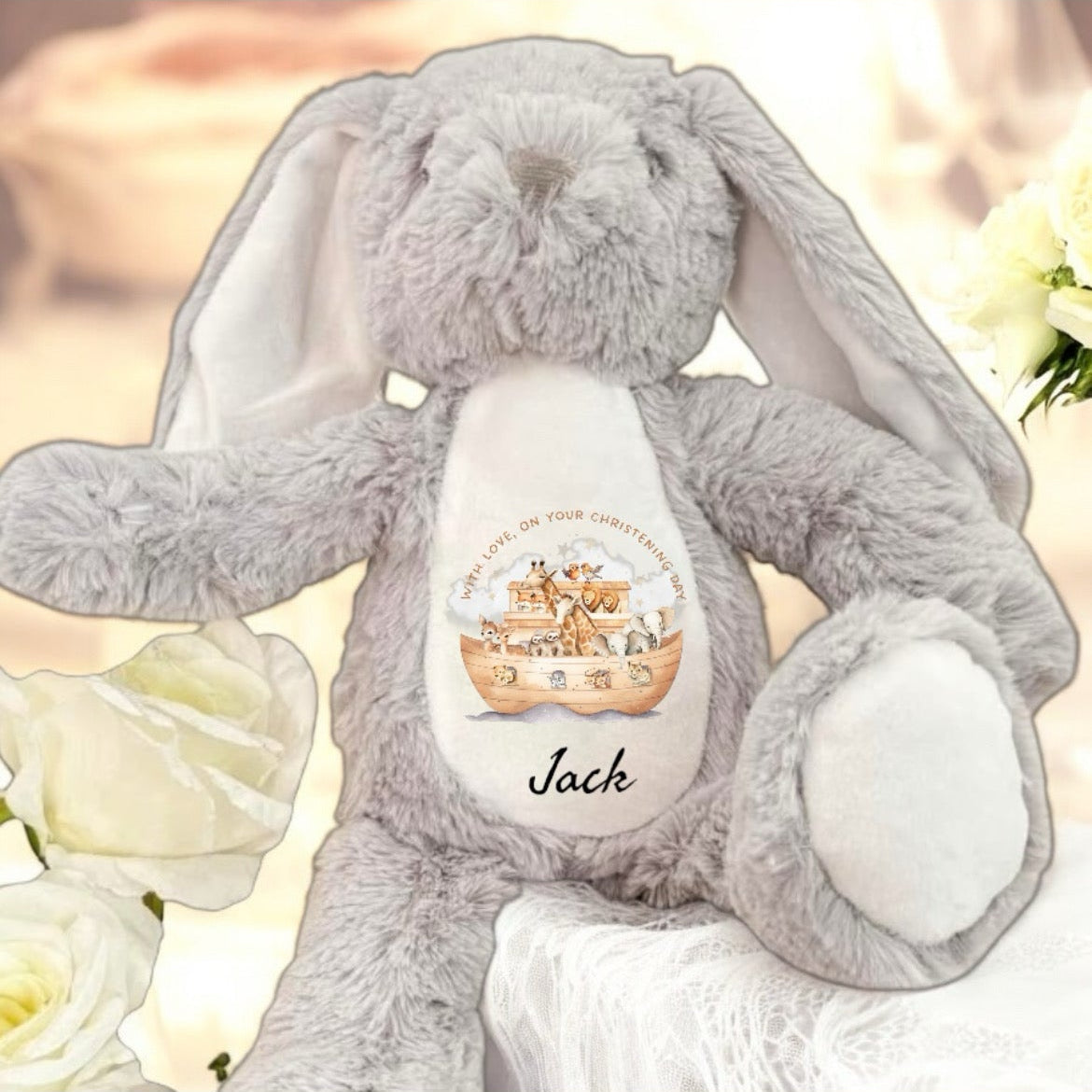 Gray plush bunny with a visible brand logo on a white background