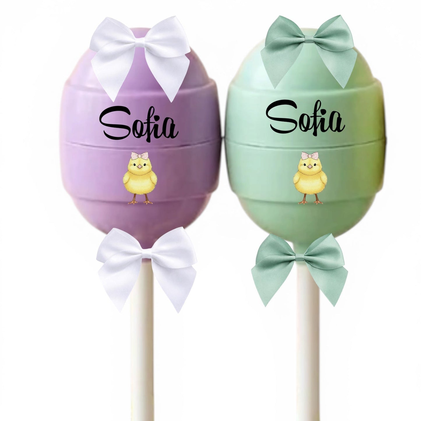 Two decorative items shaped like eggs with bows and names on a white background