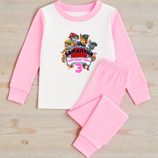 Children's pajama set with personalized design on a wooden surface