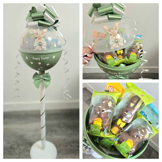 Easter-themed gift set with chocolate bunnies and a decorative stand.