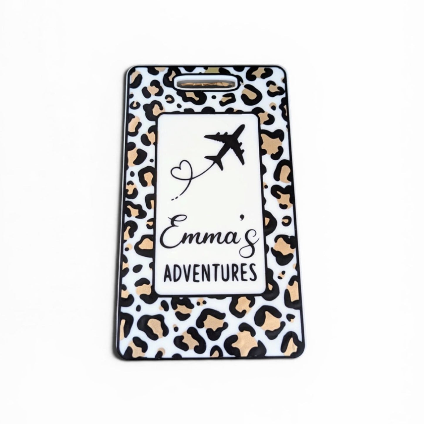 Leopard print luggage tag with 'Emma's Adventures' text and airplane design on a white background