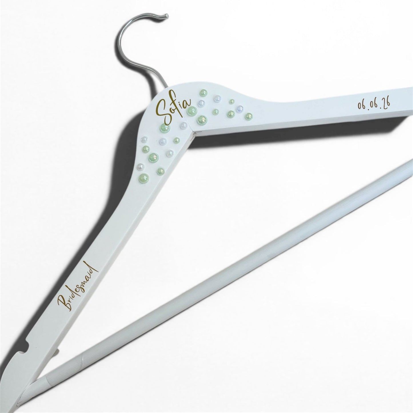 Personalized white hanger with decorative elements on a white background