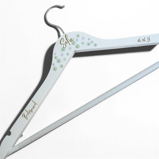Personalized white hanger with decorative elements on a white background
